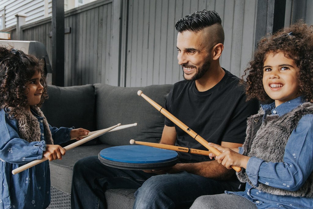 The Best Drum Sets For Kids (2024) 2 kids drumming on a practice pad