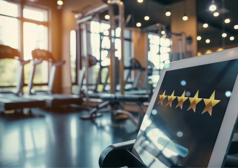 Image of a tablet displaying a 5-star review in a gym
